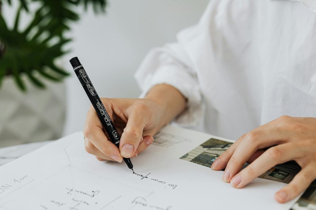 A Person Writing on White Paper